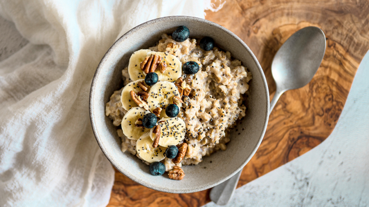 “Bowl of oatmeal topped with chia seeds, berries, and pecans, a gut-healthy breakfast option