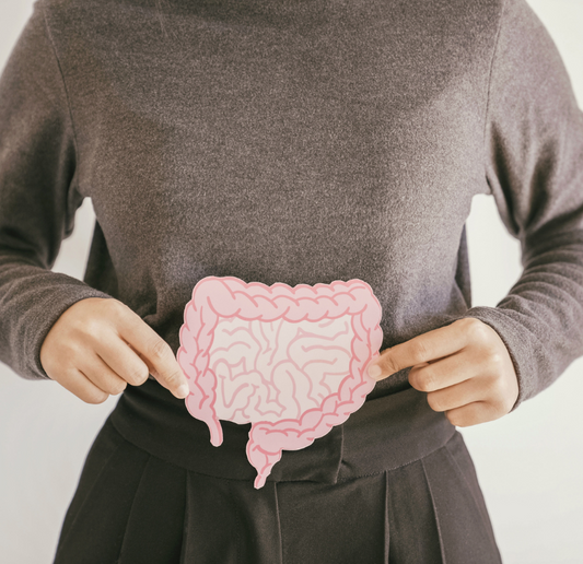 Woman holding up image of gut microbiome to show the importance of a healthy gut